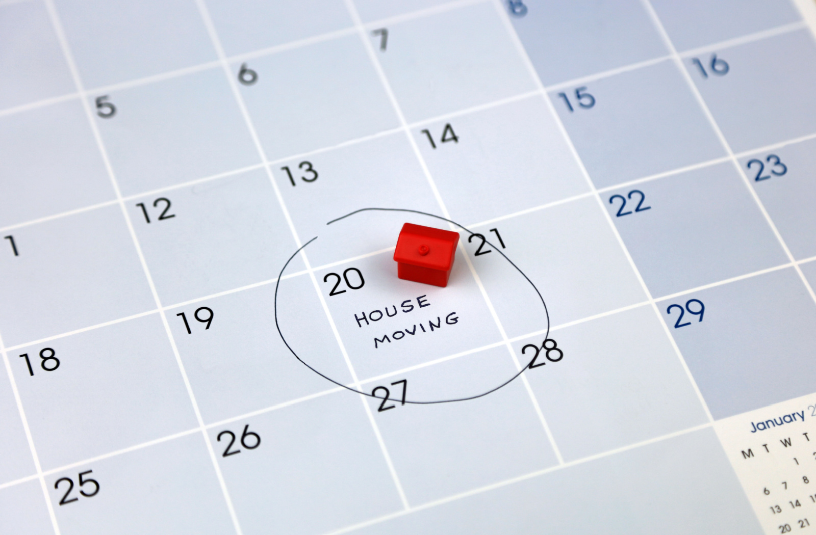 The calendar displays the scheduled house moving date, featuring a small red model house placed atop the encircled day.