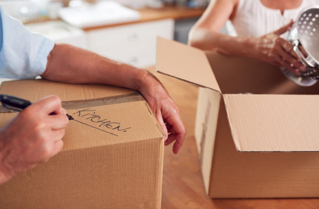 In the background, a couple is diligently labeling boxes in preparation for their move.