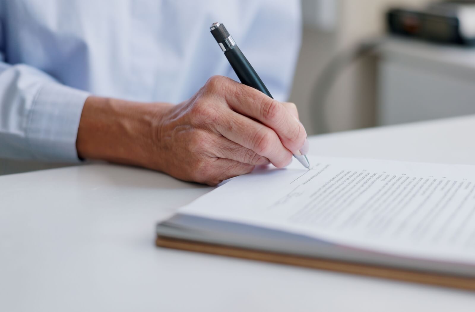 a senior with dementia signs a legal document